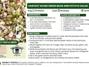 Bowl of green bean and potato salad made with tender red potatoes, fresh green beans, green onions, and basil, tossed in a light Dijon vinaigrette.