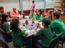 youth teams sitting at table with buzzers in hand, waiting to answer questions