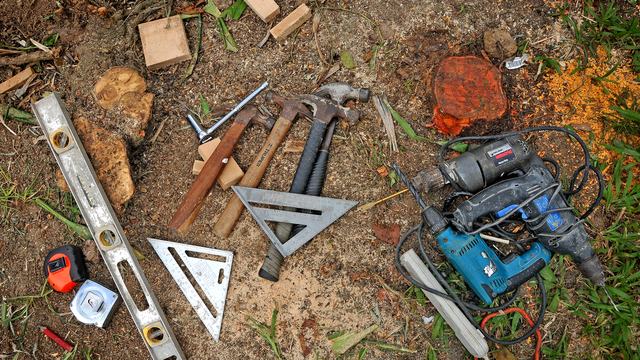 A variety of tools lay on the ground.