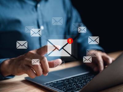 man sending emails on laptop