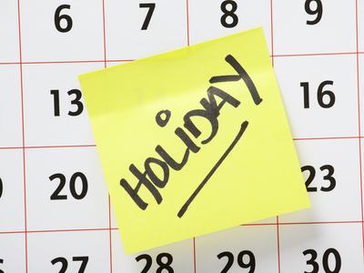 Calendar with a handwritten Holiday note on it