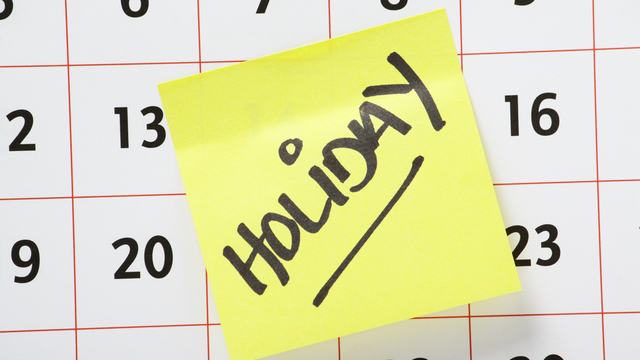 Calendar with a handwritten Holiday note on it