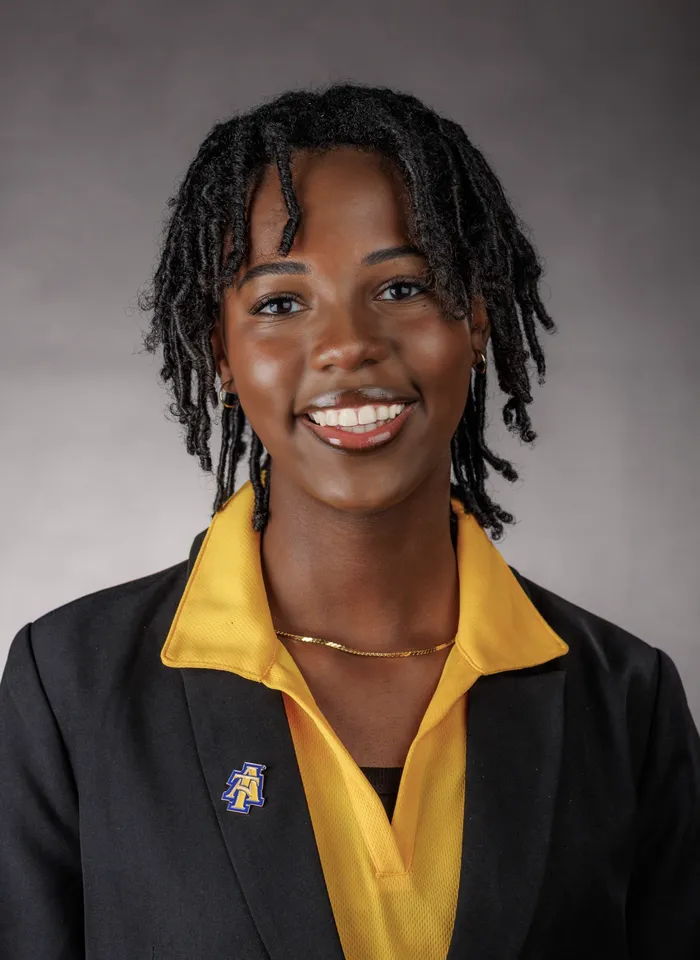 Headshot of Alivia Chasten featuring lapel pin featuring A&T university logo