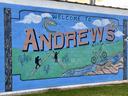 A photograph of a mural with a montage depicting cycling, fishing and hiking.  Includes headline "Welcome to Andrews."