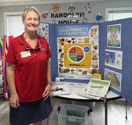 Angie standing in front of display board with whole grain image