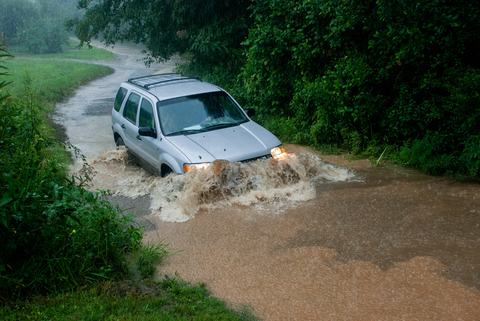 SUV crossing stream in flood