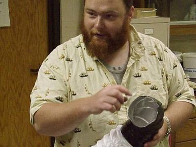 Person holding homemade apple collection device