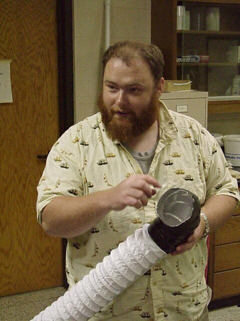 Person holding homemade apple collection device