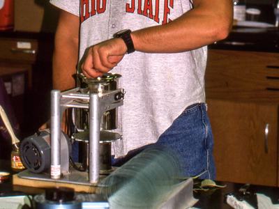 Person using mite-brushing machine