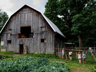 People with barn and crop field