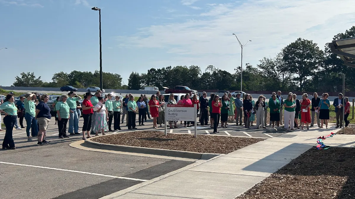 A crowd of 4-H and FFA members, Extension professionals, university representatives and guests gathers outside the CALS Extension Building for its ribbon-cutting ceremony.