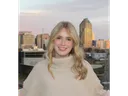 woman standing in front of a cityscape