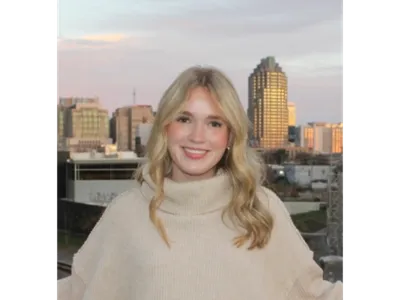 woman standing in front of a cityscape