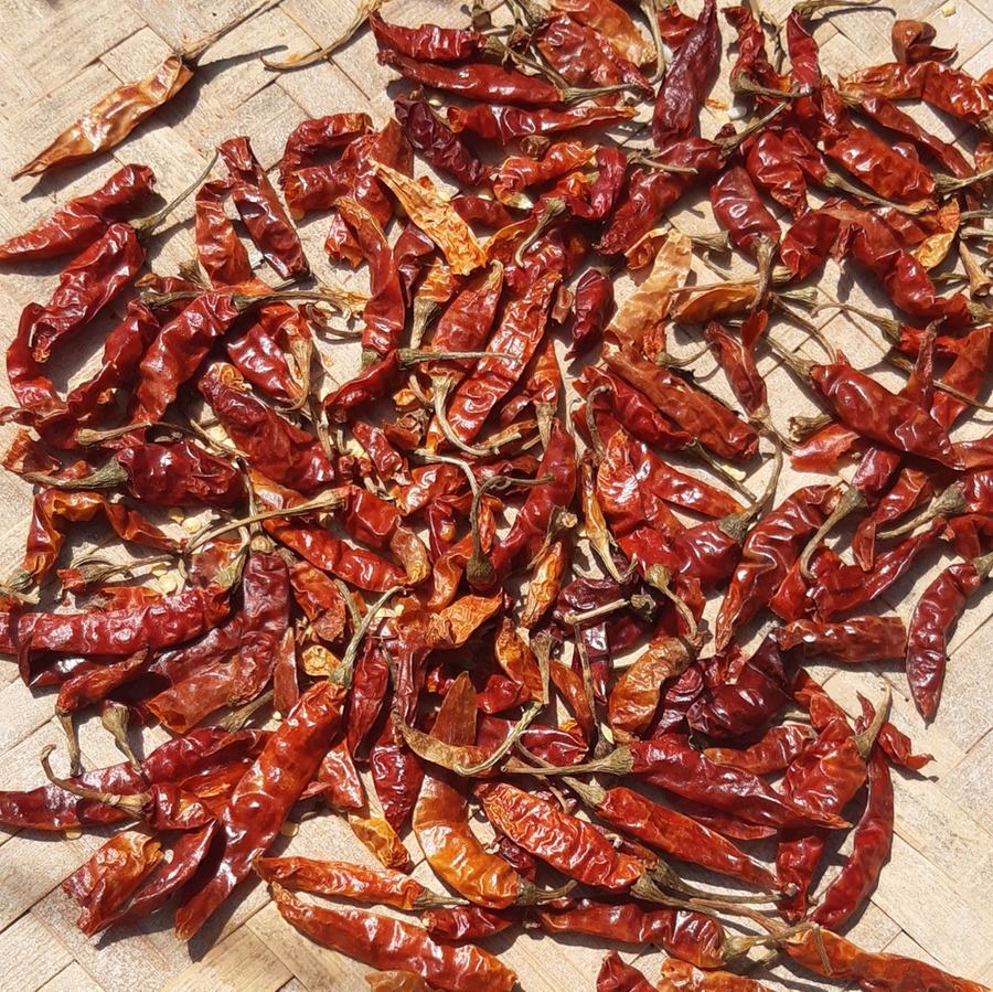Dried peppers on a white table.
