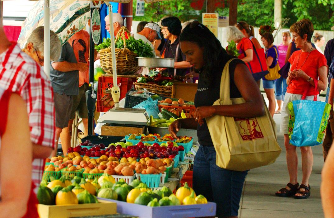 Shopper purchasing produce at the Carrboro Farmers' Market