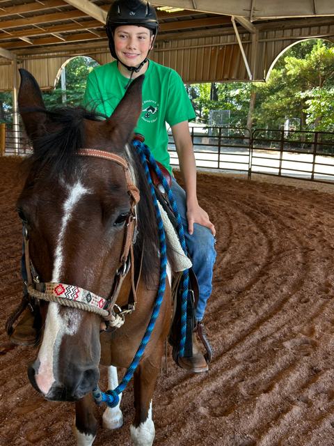 Boy riding a horse