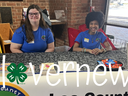 Photo of two 4-Hers manning a table at the Lee County Library