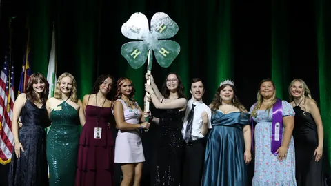 Members of the South Central District officer team pose with the state 4-H officers after receiving the Spirit Stick during the 2026 4-H Congress.
