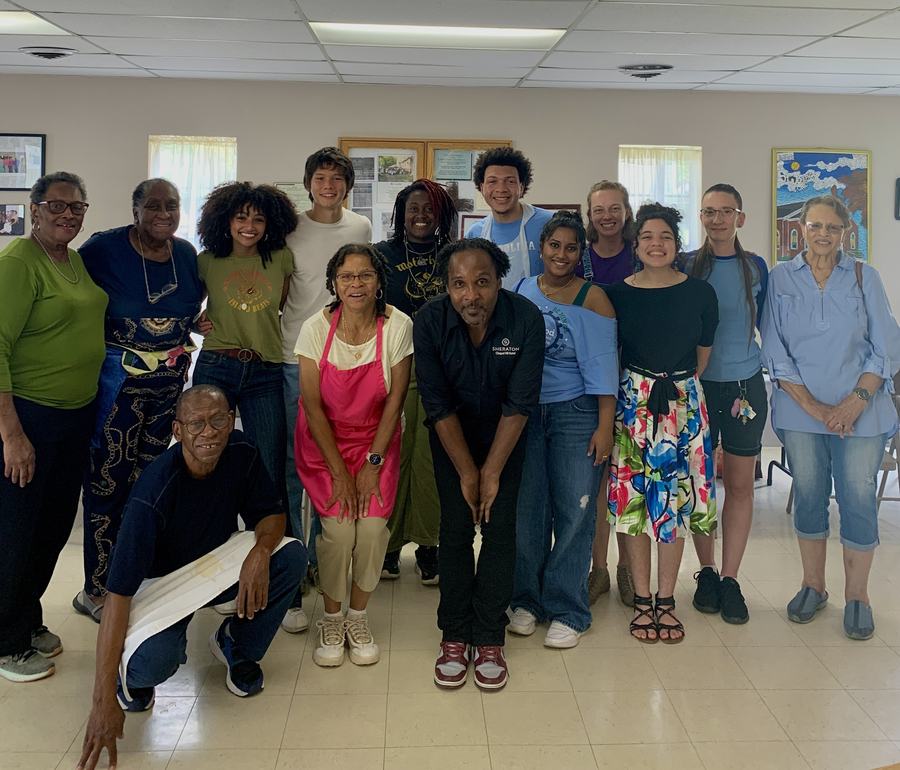 Cooking day participants taking a photo together during a class at Heavenly Groceries