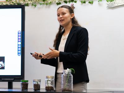 4-H member presents about energy and metabolism using a digital display and demonstration materials during North Central District Activity Day.