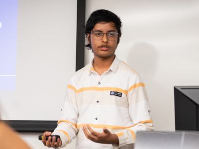 4-H member speaks to judges while presenting on xenobots during Northeast District Activity Day.