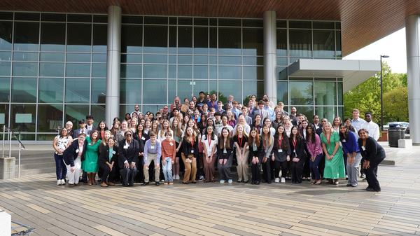 group of NC Youth Institute students and mentors outside of the Plant Sciences Building at NC State