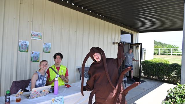 An NC State student dressed in a cockroach costume