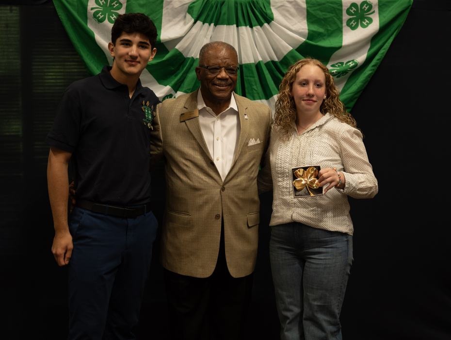 Wake County 4-H Teen Council President Kishan Virdy, Wake County Comissioner Don Mial, and Wake County 4-H Livestock Champion Charley Jennings pose for picture as Charlie accepts golden clover award