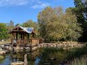 Sunny day at the Discovery Gardens near the pond and summer house.