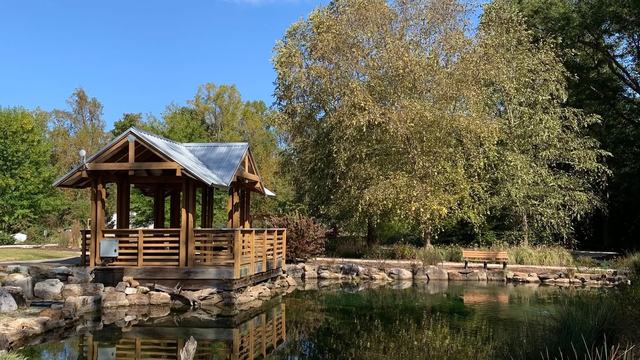 Sunny day at the Discovery Gardens near the pond and summer house.