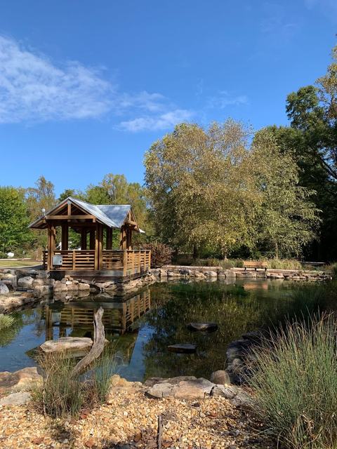 Sunny day at the Discovery Gardens near the pond and summer house.