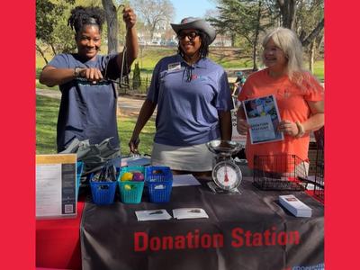 Donation Station Volunteers ring the bell to start the opening of the Belmont Farmer's Market.