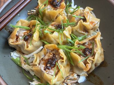 Bowl with pork dumplings and slaw.