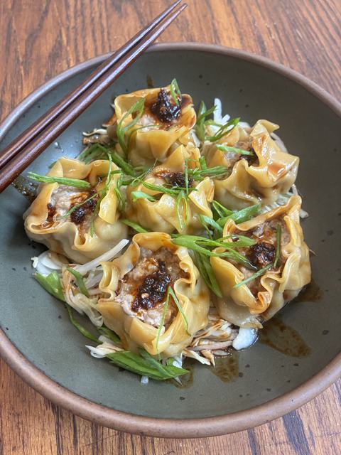 Bowl with pork dumplings and slaw.