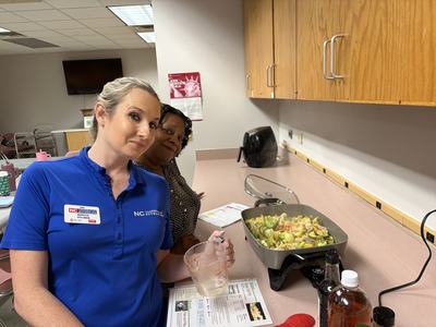 Marissa and Della making a stir fry dish