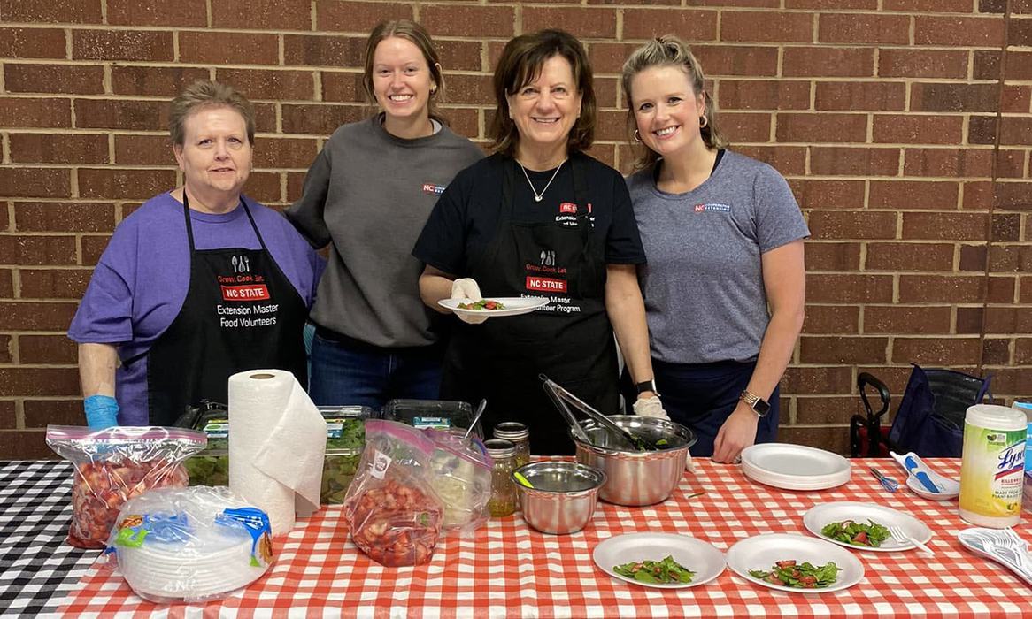 Four women serve salads at a cooking demonstration in Stanly County, North Carolina
