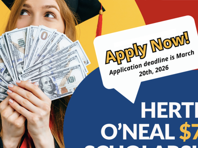 A graduating student holding money and looking happy.