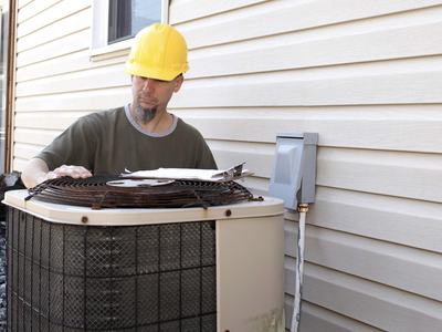 man servicing the HVAC unit at a home.