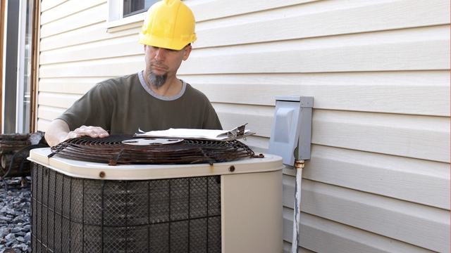 man servicing the HVAC unit at a home.