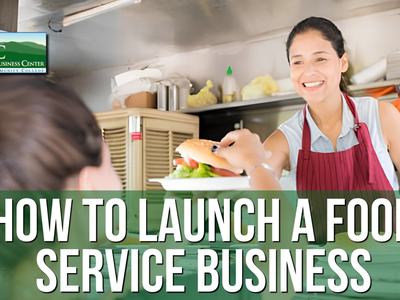 Woman serving a sandwich to customer at food service counter