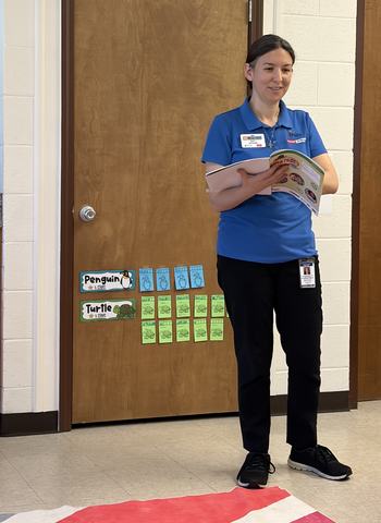 Paige reading from a workbook teaching a nutrition lesson