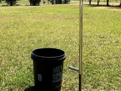 A soil probe and plastic bucket are tools that are used to collect soil samples.