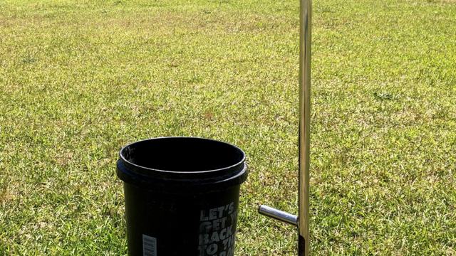 A soil probe and plastic bucket are tools that are used to collect soil samples.