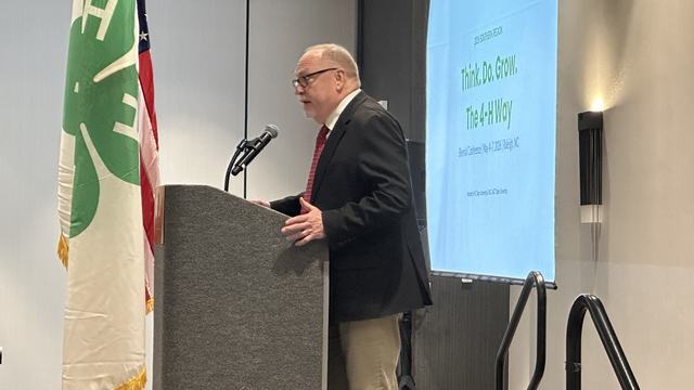 Extension Director, David Monks, stands at a podium while speaking to attendees of the 2026 Southern Region Biennial 4-H Conference.