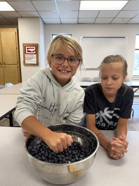 Two 4-H members learning how to make Blueberry Jam