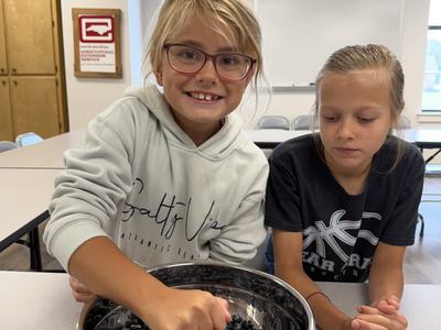 Two 4-H members learning how to make Blueberry Jam