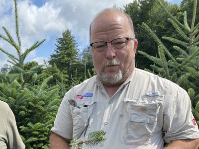Jerry Moody holds Fraser fir branch