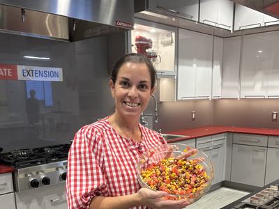 Ivy holding prepared dish in kitchen