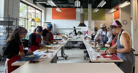 group in kitchen preparing recipes