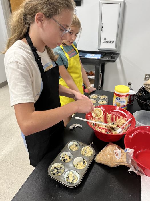 children are preparing a healthy dish at a summer program